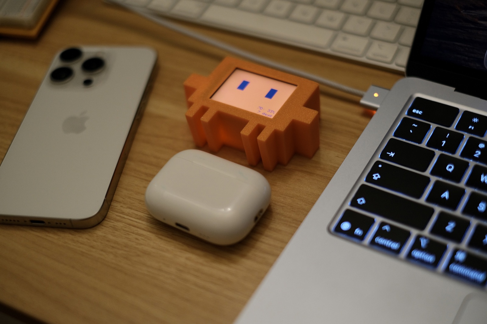 Vibe Buddy beside an iPhone, AirPods Pro, and MacBook for scale